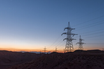 Highvoltage lines pylons in the field