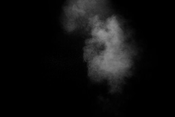 White dust cloud in the air.Abstract white powder explosion against black background.