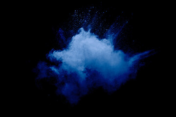 Obraz na płótnie Canvas Blue powder explode cloud on black background.Launched blue dust particles splash on background.