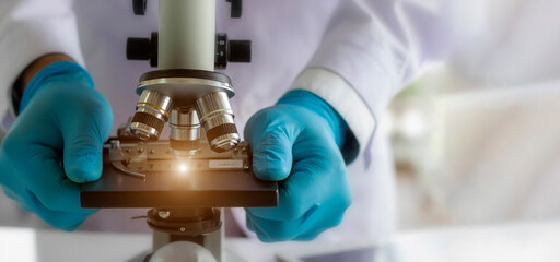 Laboratory concept; The scientist uses the microscope for research in a laboratory.