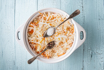 Grated cabbage and carrot with salt and pepper