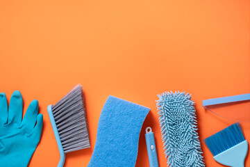 House cleaning blue color product on orange table background, clean service concept