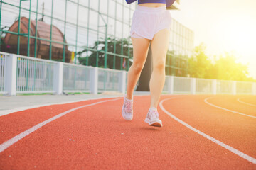 Obraz premium Athlete beautiful woman, teen Jogging and exercise on the treadmill for the sunset background Health and lifestyle concepts