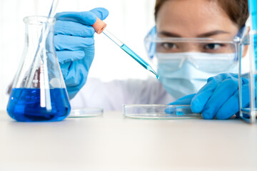 Fototapeta premium Medical scientists released a sample pipetted into test glassware to analyze the virus in a chemical laboratory. Scientific research concepts