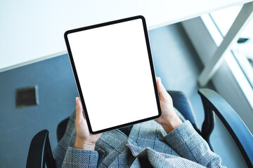 Top view mockup image of a business woman holding black tablet pc with blank white desktop screen