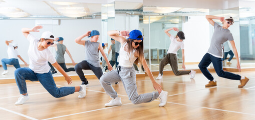 Joyous boy and girls dancing hip hop at lesson in the dance class