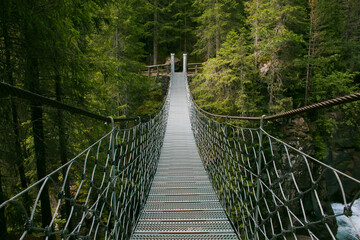 View of suspended tibetan bridge in the Natural Park of Paneveggio Pale di San Martino, Val di...