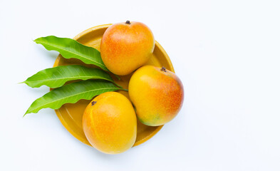 Tropical fruit, Mango on yellow plate on white background.