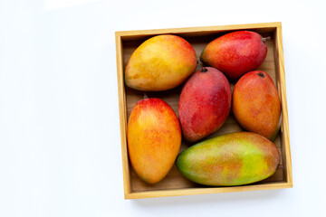 Fototapeta na wymiar Tropical fruit, Mango in wooden box on white background.