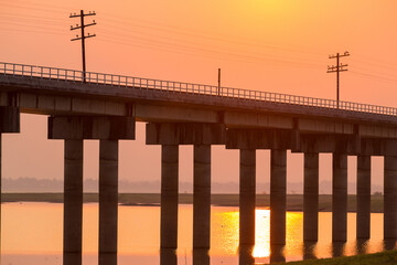 Rail way bridge cross over the dam with morning sky.