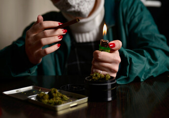 Young woman with face mask smoking weed flame lighter hands nails marijuana 