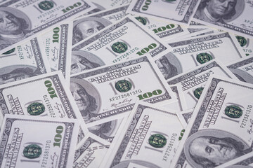 Top view pile of one hundred dollars as background. Texture US dollars.
