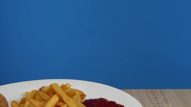 French fries with Kiev cutlet with red sauce spinning