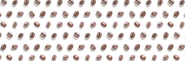 Many coffee beans at white background. Isolated pattern seeds. Roast arabica restaurant concept. Taste energy brown morning beverage. Cafe wallpaper. Horizontal banner. Hard shadows - obrazy, fototapety, plakaty