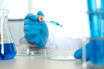 Fototapeta premium Medical scientists released a sample pipetted into test glassware to analyze the virus in a chemical laboratory. Scientific research concepts