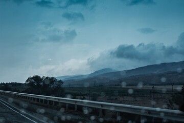 road in the rain against the background of mountains