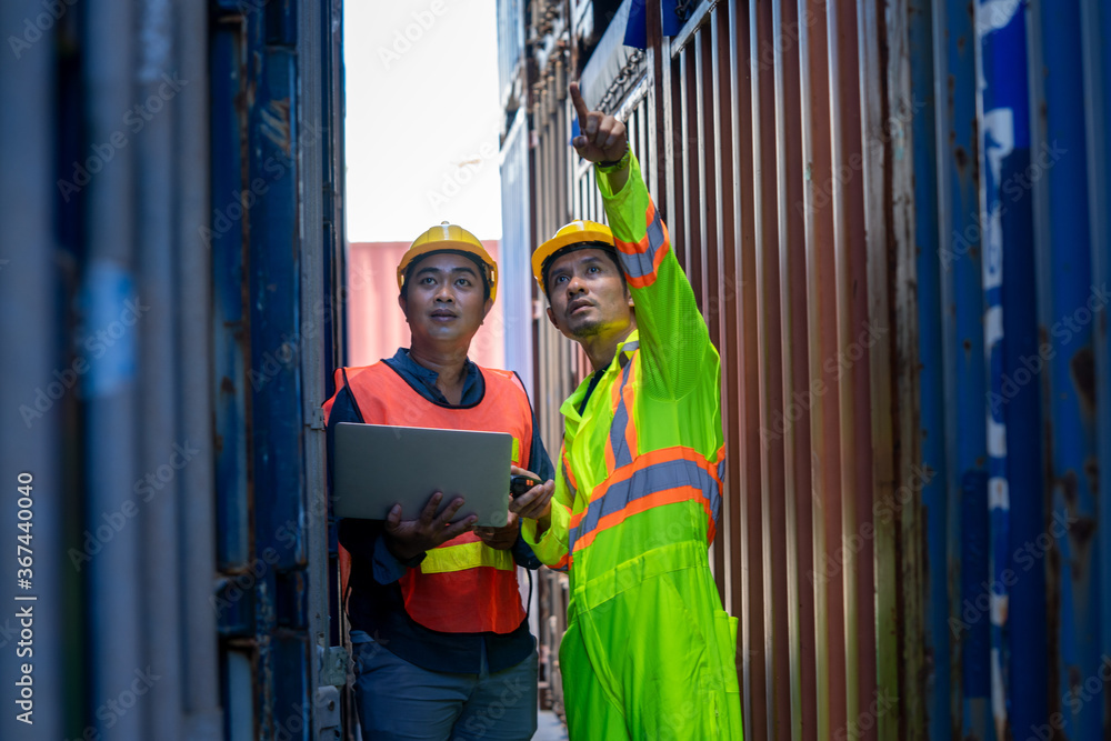 Poster two foreman workers discussing and checking in shipping yard at container cargo.