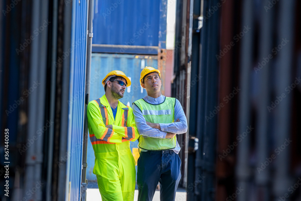 Poster logistic warehouse foreman using laptop checking list of container boxes from cargo.