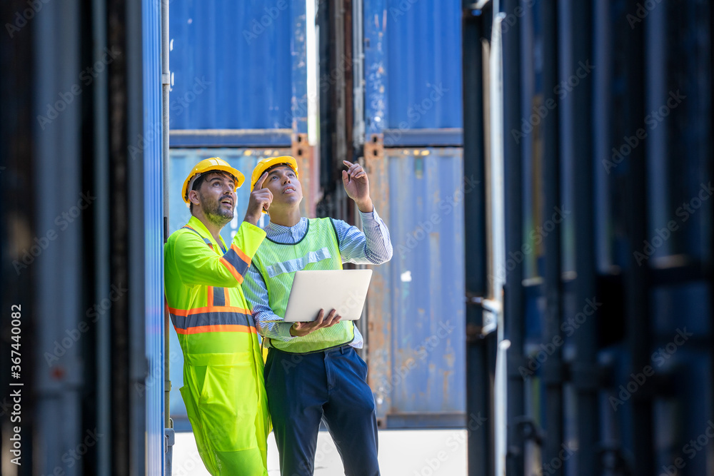 Poster logistic warehouse foreman using laptop checking list of container boxes from cargo.
