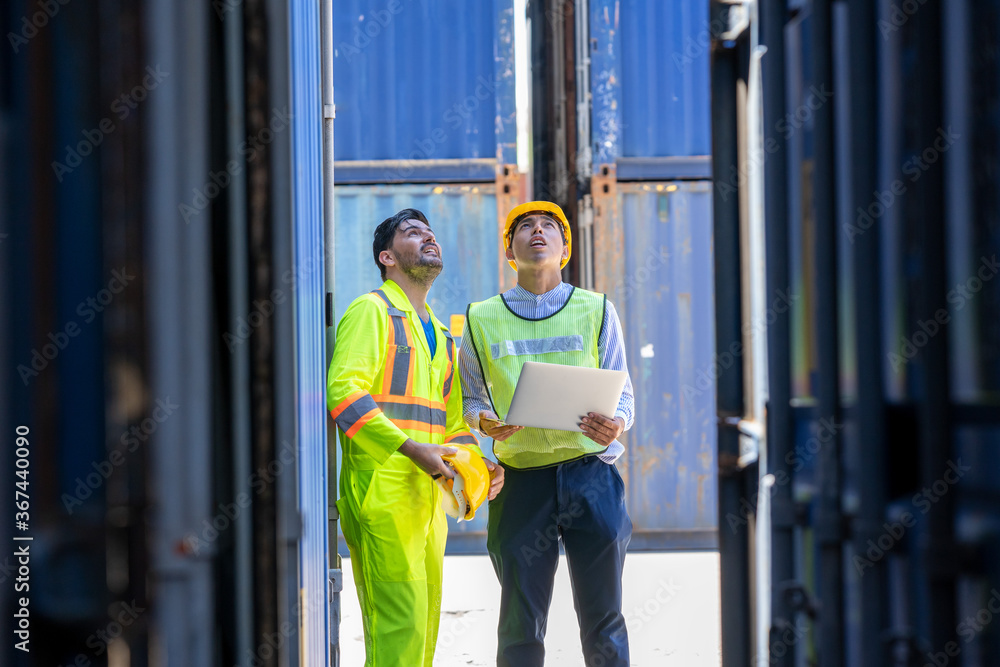 Poster two foreman workers discussing and checking in shipping yard at container cargo.
