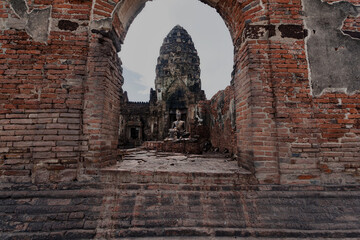 The old castle and the Buddha statue are made of stone. There are many monkeys
