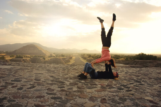 Two girls doing stunts in the Teotihuacan pyramids. Girls doing stunts on pyramids in Mexico. Pyramid of the sun, Teotihuacan. Travels and tourism