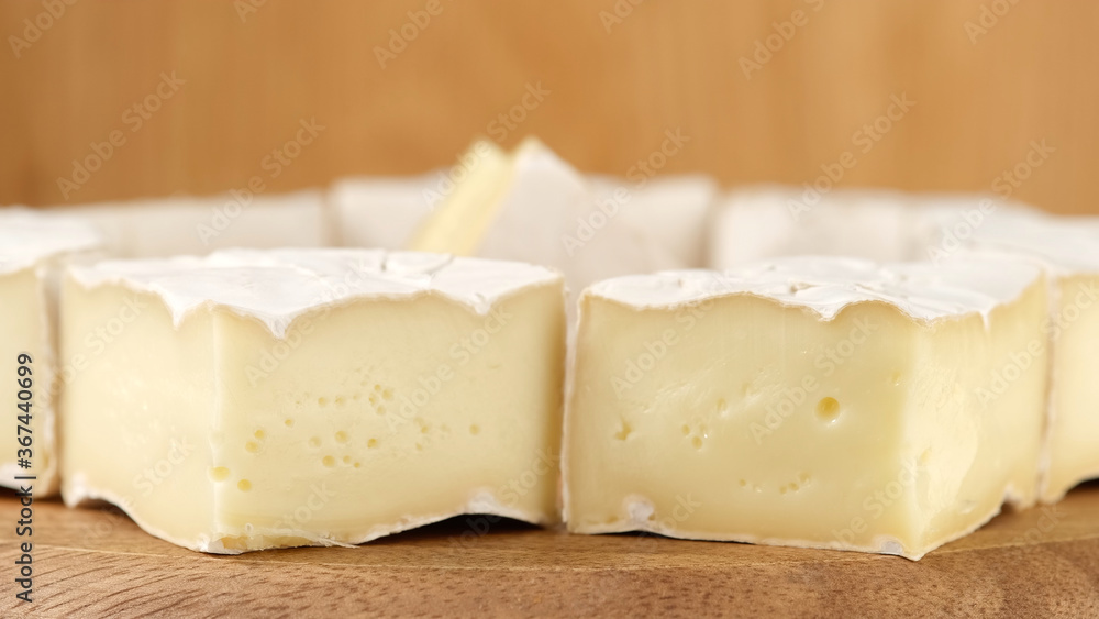 Wall mural cheese camembert delicious pieces of white mold cheeses with soft textures camembert close up