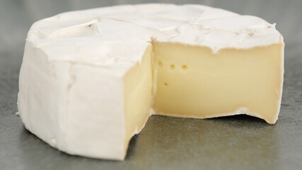 Camembert cheese close up. Rotation pieces of soft cheese Camembert. Delicious pieces of white mold cheeses with soft textures