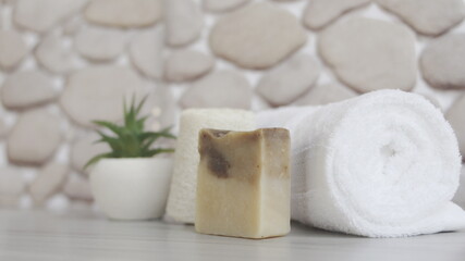 Soap dispenser and spa towel ,Roll up of white towels on white table with copy space,towels studio shot on white table