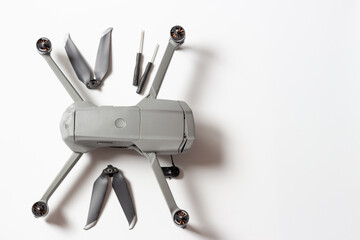 A quadracopter disassembled on a white background, copy of the space