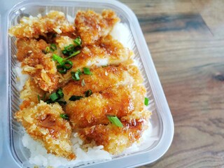 Fried chicken teriyaki with rice. Online food delivery and takeaway concept.