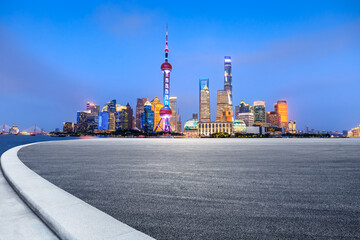 Empty asphalt road and city skyline and buildings at night in Shanghai,China.