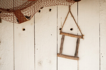 An empty wooden frame on a wall of white boards.