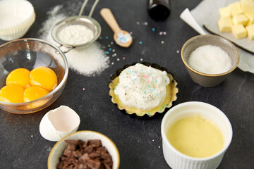 food, culinary and recipe concept - baking dish with dough and cooking ingredients on table