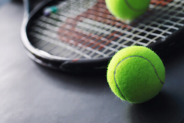 Sport and healthy lifestyle. Tennis. Yellow ball for tennis and a racket on the table. Sports background with tennis concept.