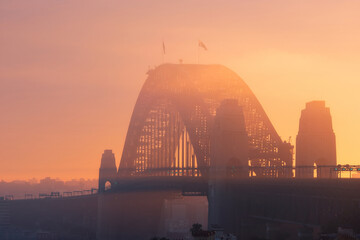 Golden light over the fog at Sydney Harbour Bridge.