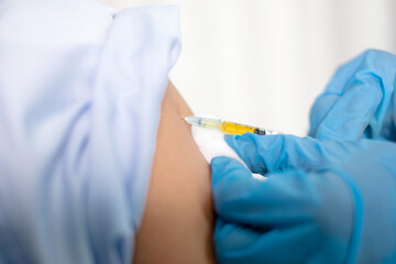 Female doctors vaccinated with syringes to prevent epidemics at hospitals, health care, and medical...