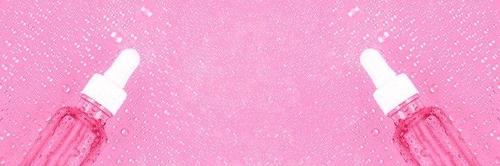 Essence moisturizing serum in glass bottle with white pipette on pink background with water drops. Hyaluronic acid for hydration. Cosmetics concept. Products for makeup and skin care. Banner. Top view