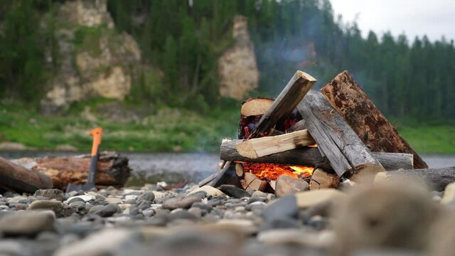 Bonfire near the river in the taiga