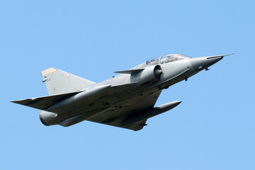 Fototapeta na wymiar Fast military jet aircraft flying at high speed.
