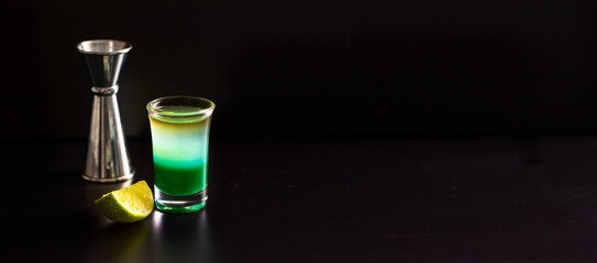 Layered alcohol shot on black large background for banner .Copy space