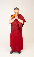 Buddhist monk recites a mantra dressed in a red kesa