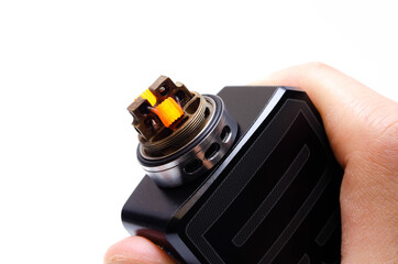 Voopoo drag 2 with Pnp Tank and tank with coils. Hot, red vape coils. Refueling steam in close-up...