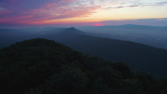 An aerial shot (dolly out) at sunrise above Duncan Knob in the Massanutten Range in George Washington National Forest in Page County, VA. 