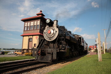 A smoke steam locomotive operated by the Strasburg Rail Road stops and awaits departure at the train station in Strasburg, Lancaster County, Pennsylvania. 