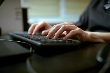 Female hands or woman office worker typing on the keyboard