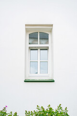 window in a building with a white wall