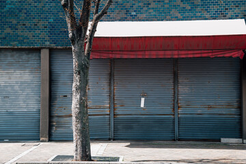 Closed metal shutter door of building. Japanese street view