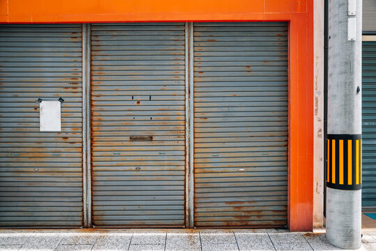 Closed metal shutter door of building. Japanese street view