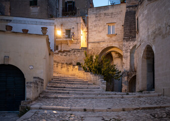 Fototapeta na wymiar Typical cobbled stairs in a side street alleyway iin the Sassi di Matera a historic district in the city of Matera. Basilicata. Italy